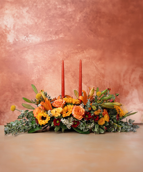 fall themed flower arrangment with vandles 