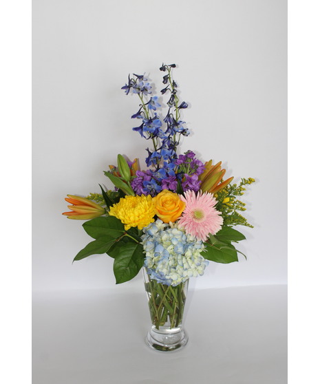 Bouquet of lilies, gerbera daisies, roses, hydrangea, snapdragons and more in a clear glass vase